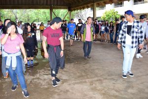 Mr. Wayne Mendoza, Philippine Dance Master, shows the participants the steps to the country dance, Tiklos.